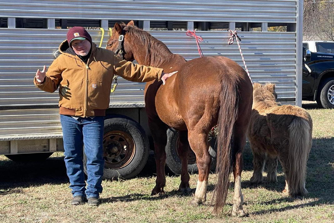 Someone posing with a horse.